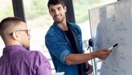 business-young-man-pointing-on-whiteboard-while-di-2022-12-15-18-19-03-utc.jpg